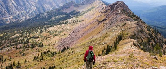 hiker walking along a mountain ridge in the Montana wilderness