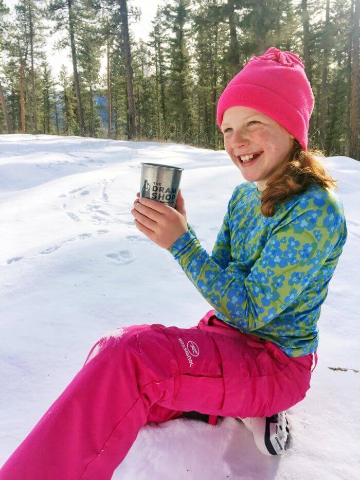 drinking hot chocolate after sledding on a snowy hillside