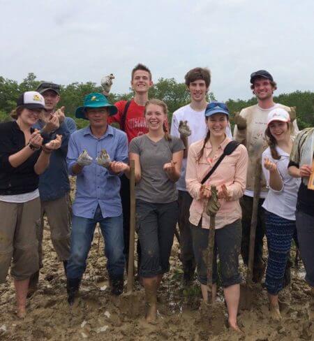 University of Montana students getting their hands dirty on a climate change class field session in Vietnam