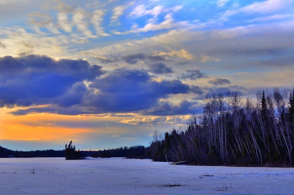 beautiful clouds during sunset above a wintry, snowy landscape